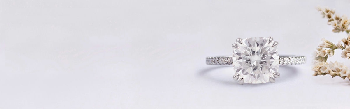 half eternity and moissanite cushion cut engagement rings