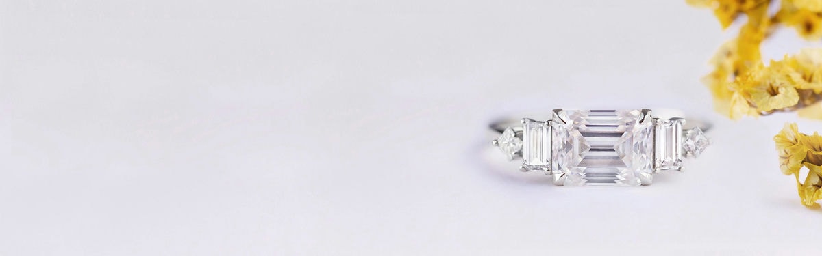 moissanite and diamonds east west engagement ring set in white gold