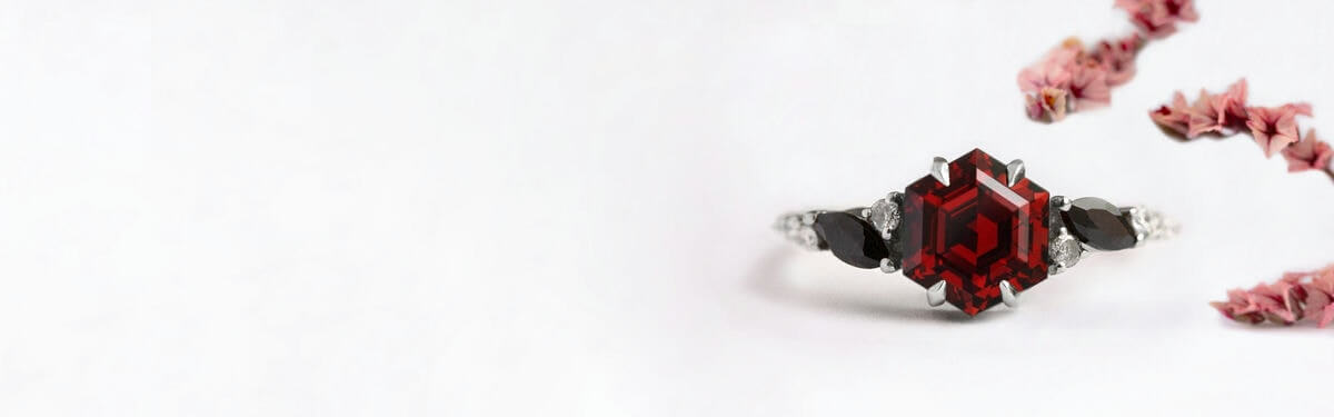 dark red garnet engagement ring with claw prongs in white gold