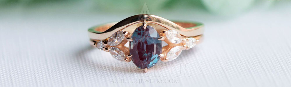 gold engagement ring with alexandrite stone and diamonds