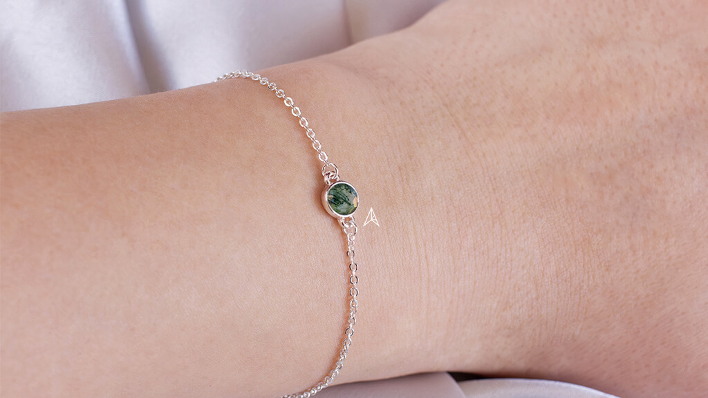 hand with a moss gemstone bracelet