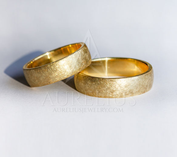 two gold rings with brushed finish surface