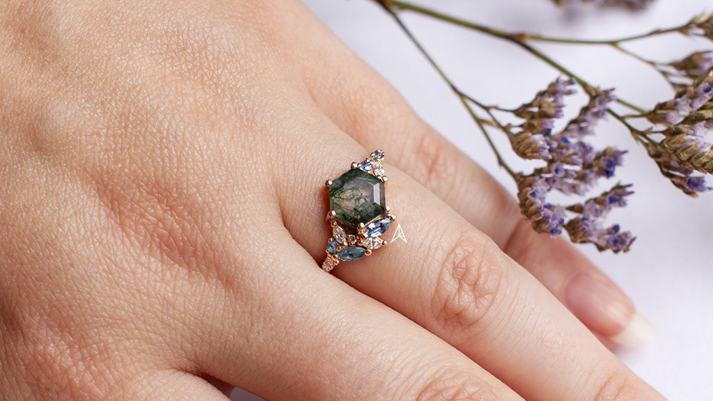 a great example of a moss agate engagement ring on a woman's hand