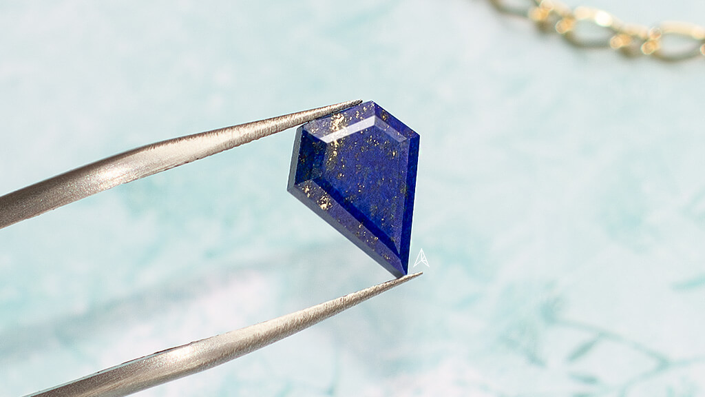 close up inspecting blue gemstone