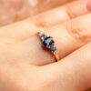 profundo azul zafiro anillo en la mano